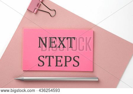 Pink Sticker On Pink Paper With Pencil On White Background With Text Next Steps