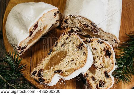 Christmas Stollen On Wooden Background. Traditional Christmas German Dessert Cut Into Pieces. Cake W