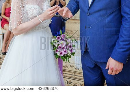 Bride And Groom Marriage Hands With Wedding Rings. Bride Hand Putting Wedding Ring On Groom Finger. 