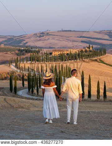 Couple Man And Woman On Vacation In Italy Toscane Watching The Golden Hills Of Toscane In Italy Euro