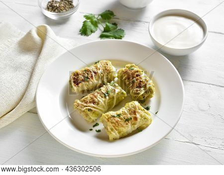 Cabbage Rolls Stuffed With Meat On Plate Over Light Wooden Background. Close Up View