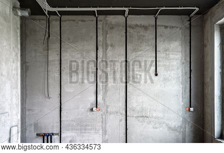 Electrical Cables And Pipes On House Concrete Wall. Modern Plastic Hoses And Conduits With Wires In 