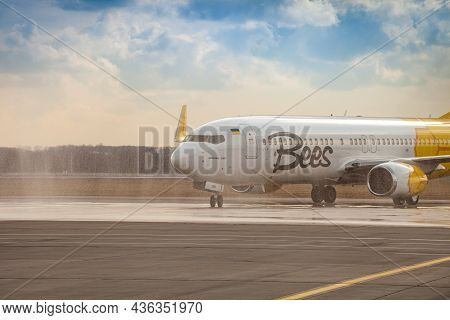 Bees Airline Yellow Plane On The Apron. Boeing 737-800 Ur-uba Passenger Aircraft. Ukraine, Kyiv - Ma