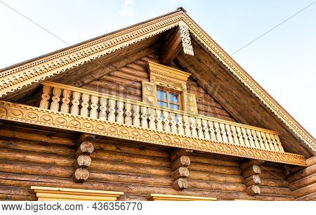 Russian Traditional Wooden Architecture. Facade Of New Wooden House Decorated With Wooden Carvings, 