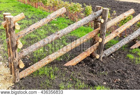 Fence Made Of Natural Wooden Poles At The Countryside In Summer