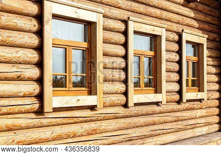 Russian Traditional Wooden Architecture. Windows Of New Wooden House Decorated With Wooden Platbands