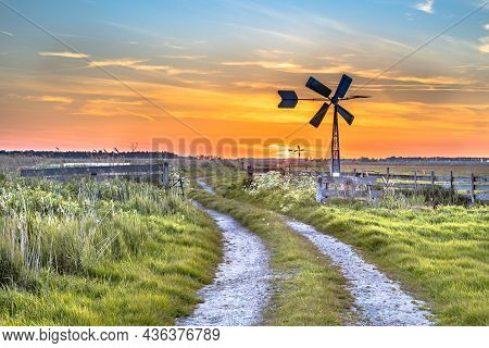 Old American Windmill At Sunset In Dutch Rural Landscape Near Jisp, Noord Holland, Netherlands