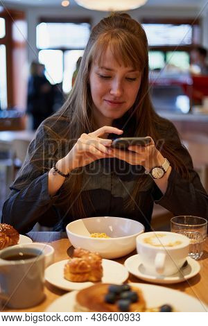 Beautiful Young Female Student Taking Photos Of Sweet Dessert And Flat White Coffee On Smart Phone O
