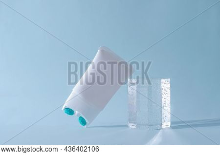 Cream Lifting With Massage Nozzle In A White Tube On A Blue Background With A Podium Of Plexiglass