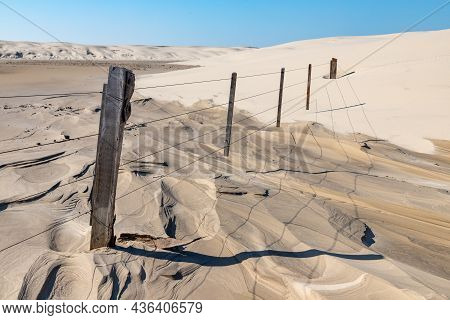 Wood And Iron Fence In Dunes