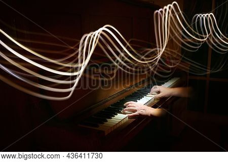 Light Painting In The Form Of Curved Stave Lines Above Hands Playing On An Old Piano, Waves Of Music