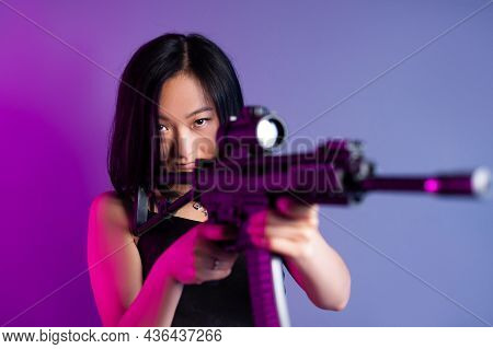 Asian Woman With A Machine Gun Aims For Shooting