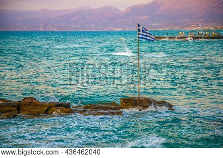 Aegean Sea Coastline With Greek Flag In Foreground. Romantic Beach Baldachins In Background, Availab