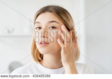 Under Eye Cream. Skincare Moisturizing. Morning Treatment. Pretty Young Woman Applying Beauty Produc