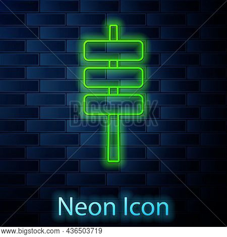 Glowing Neon Line Korean Food Tokpokki Icon Isolated On Brick Wall Background. Vector