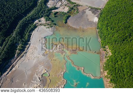 Drone View Of The Turquoise Lake Formed As A Result Of Mining Waste