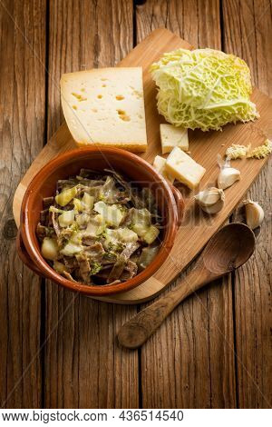 Pizzoccheri pasta with ingredients over wooden background