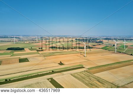 Windmill Among Agricultural Fields. Wind Turbine Generator At Summer Day. Wind Energy Concept. Suist