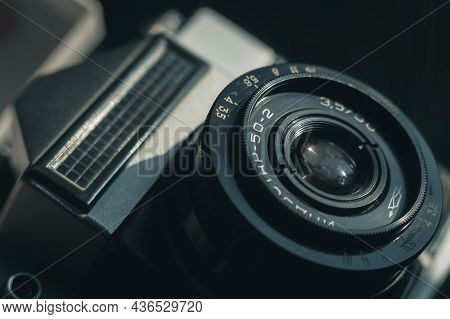 Close-up Of The Soviet Manual Lens Industar 50-2 On A Film Camera. Black Background, Copy Space, Dee