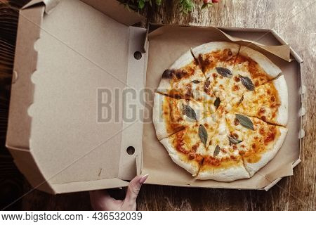 Close-up Of Margarita Pizza In A Disposable Dish. Top View Of Takeaway Food In A Fast Food Cafe. On
