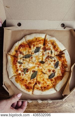 Close-up Of Margarita Pizza In A Disposable Dish. Top View Of Takeaway Food In A Fast Food Cafe. On
