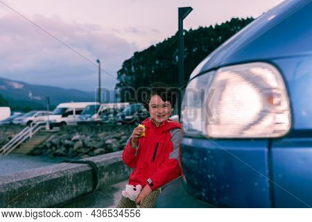 Young Girl Rests Upright In A Camper Van.