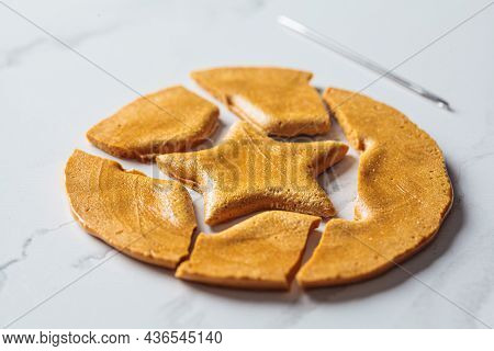 Dalgona Candy - South Korean Treat. Round Sugar Cookie With A Star Inside, Close-up.