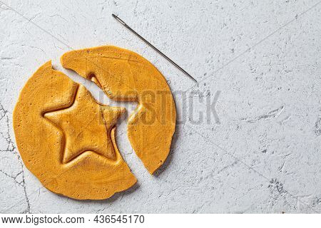 Dalgona Candy - South Korean Treat. Round Sugar Cookie With A Star Inside, Top View.