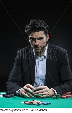 Gambling And Casino Concepts. Serious Caucasian Young Handsome Pocker Player Staking And Betting To