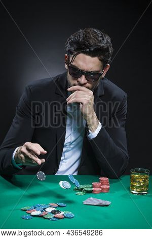 Gambling And Casino Concepts. Caucasian Young Handsome Pocker Player Staking And Betting To Win At P