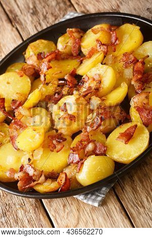 Bratkartoffeln German Cottage Potatoes With Bacon And Onion Close Up In The Plate On The Table. Vert