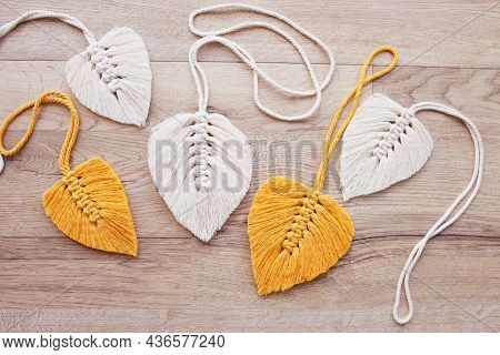 Macrame Leaves In Yellow  And Natural Color On The Wooden Background. Cotton Rope Decor Macrame To M