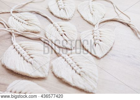 Macrame Leaves In Natural Color On The Wooden Background. Cotton Rope Decor Macrame To Make Your Hom