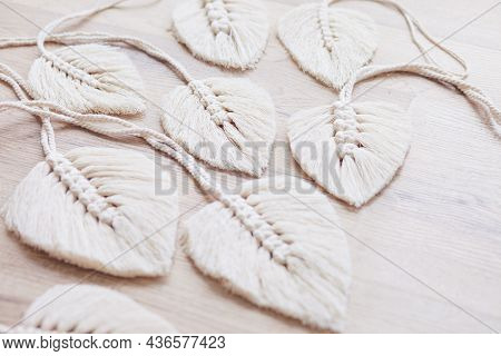 Macrame Leaves In Natural Color On The Wooden Background. Cotton Rope Decor Macrame To Make Your Hom