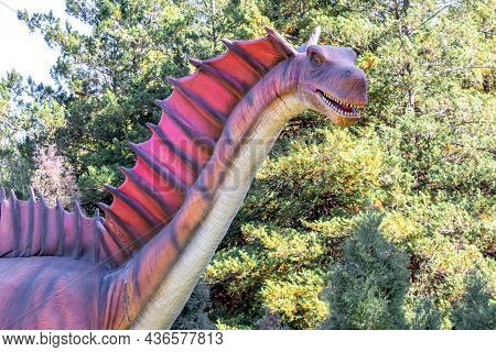 Ukraine, Khmelnitsky, October 2021. Dinosaur, Amargasaurus Close Up With Open Mouth And Sharp Teeth.