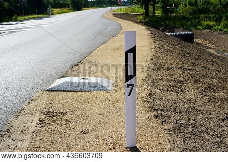 Reconstructed Road Edge With Plastic Road Post With Reflector And Concrete Speed Bump With A Reflect