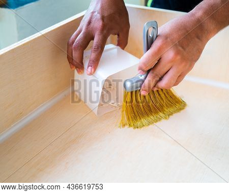 Cleaning And Home Concept - Close Up Of Male Brooming Wooden Floor With Small Whisk Broom And Recycl