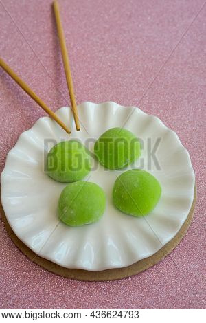 Japanese Dessert With Malaysian Fusion, Pandan Mochi In Green Colour On A White Plate With Chopstick