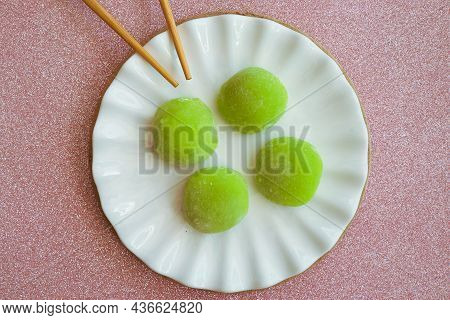 Japanese Dessert With Malaysian Fusion, Pandan Mochi In Green Colour On A White Plate With Chopstick