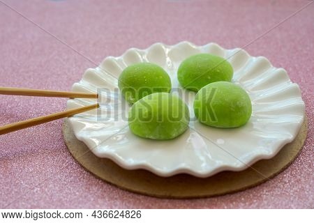 Japanese Dessert With Malaysian Fusion, Pandan Mochi In Green Colour On A White Plate With Chopstick