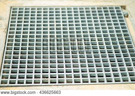 Closeup Drain Sump And Grating On The Floor In Outdoor.