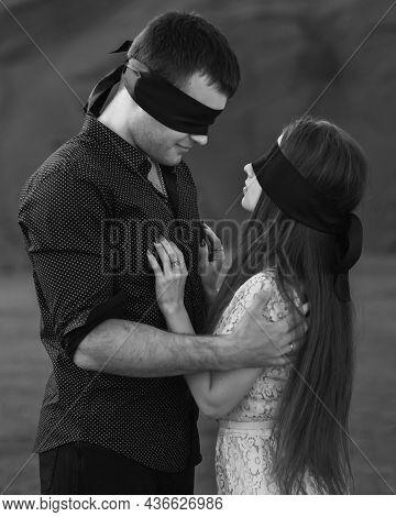 Romantic Couple Blindfolded With Black Ribbon. Love Blind Concept. Black And White