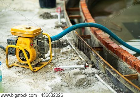 Portable Electric Generator Engine. Self-priming Water Pump Diesel Engine In A Construction Site. Ro