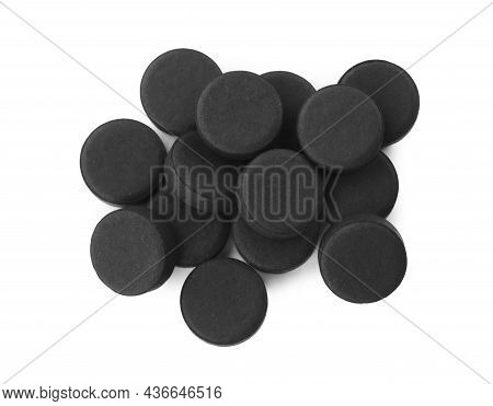 Activated Charcoal Pills On White Background, Top View. Potent Sorbent