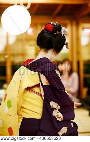 Maiko Apprentice Showing Japanese Traditional Dance. Maiko Is An Apprentice Geisha. Maikos Performin