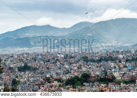 A View Of The Population Density In City Of Kathmandu Under A Stormy Sky With An Airplane Coming In 