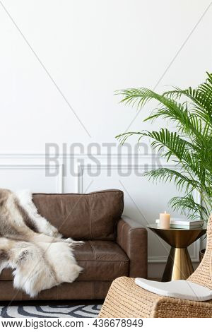 Cozy modern industrial style room with animal fur throw and rattan armchair
