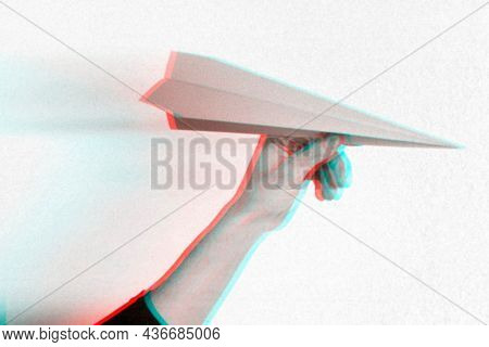 Anaglyph effect on hand holding paper plane