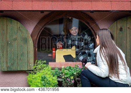 Through The Window You Can See A Girl Playing In A Small Dwarf House In An Amusement Park, Tervete
