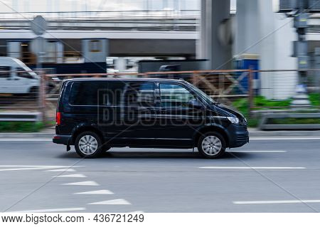 Moscow, Russia - August 2021: Volkswagen Transporter T6 On The City Road. Black Van Rides On Street.